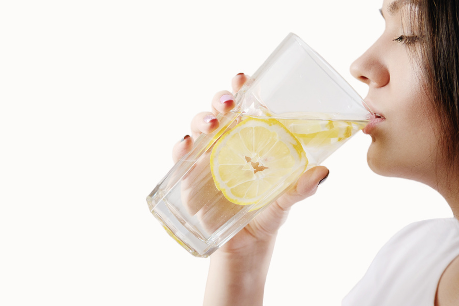 Girl Drinks Water with Lemon Concept of Proper Nutrition